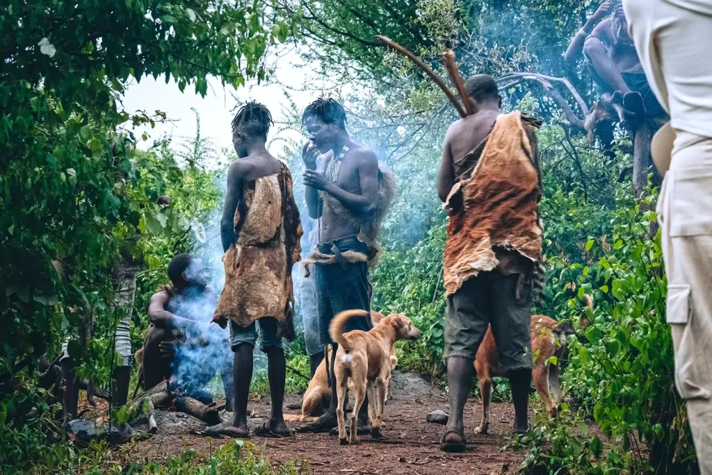 Hadzabe tribe lighting a fire in the wild Adventure Awaits: Experience a Budget Tanzania Safari and discover authentic cultural traditions with PAG Safaris.
