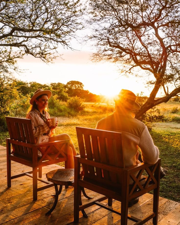 Couple watching a golden sunset over Serengeti National Park during their romantic Budget-Tanzania-Safari-Honeymoon-Adventures with PAG Safaris.