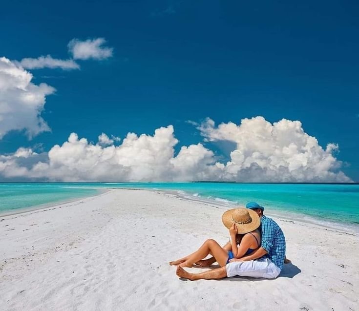 Couple relaxing on the white-sand beaches of Zanzibar during their romantic Budget-Tanzania-Safari-Honeymoon-Adventures with PAG Safaris.